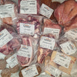 Wishbone Heritage Farms bone-in ultimate value bundle — chicken leg quarters, whole wings, spicy chicken patties, pork riblets, bone-in skin-on chicken thighs, center cut pork chop, bone-in ribeye steak, short ribs, osso buco, pork shoulder butt, maple breakfast sausage, and beef taco mix in vacuum-sealed packaging — Saint George, SC