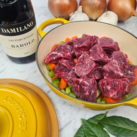 Grass-fed beef stew cubes brasato prep in a yellow Le Creuset Dutch oven with carrots, celery, onions, bay leaves, and Barolo — Wishbone Heritage Farms, Saint George, SC