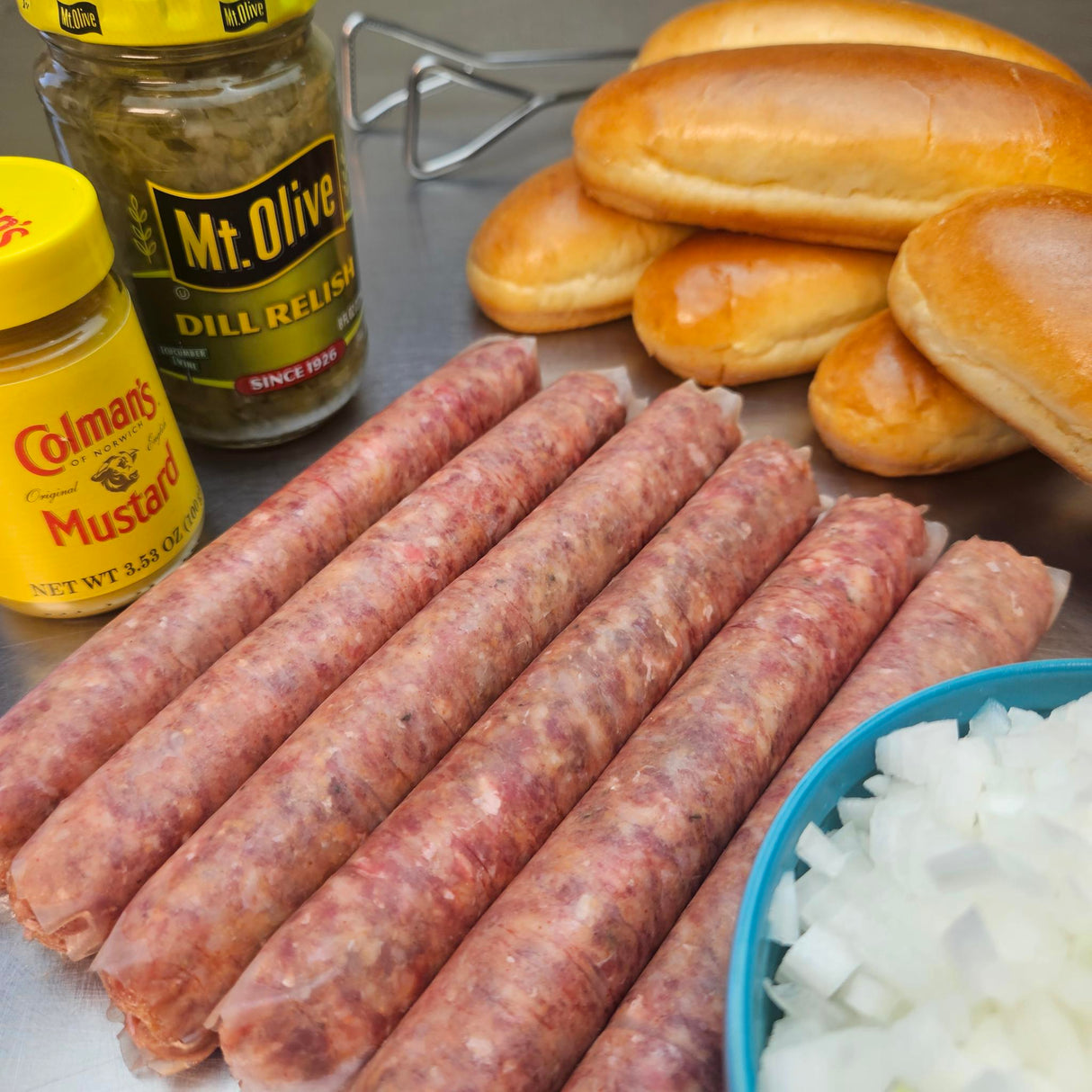 Raw grass-fed beef can't call it a hot dog longaniza sausage links with brioche hot dog buns, diced onions, dill relish, and Colman's mustard — Wishbone Heritage Farms, Saint George, SC