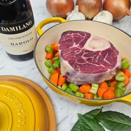 Grass-fed beef osso buco brasato prep in a yellow Le Creuset Dutch oven with carrots, celery, onions, bay leaves, and Barolo — Wishbone Heritage Farms, Saint George, SC