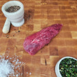 Grass-fed beef petite tender steak on an end-grain butcher block with flake salt, cracked pepper, and chimichurri — Wishbone Heritage Farms, Saint George, SC