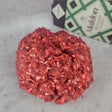 Fresh grass-fed ground beef with organs on white marble with Maldon sea salt — Wishbone Heritage Farms, South Carolina