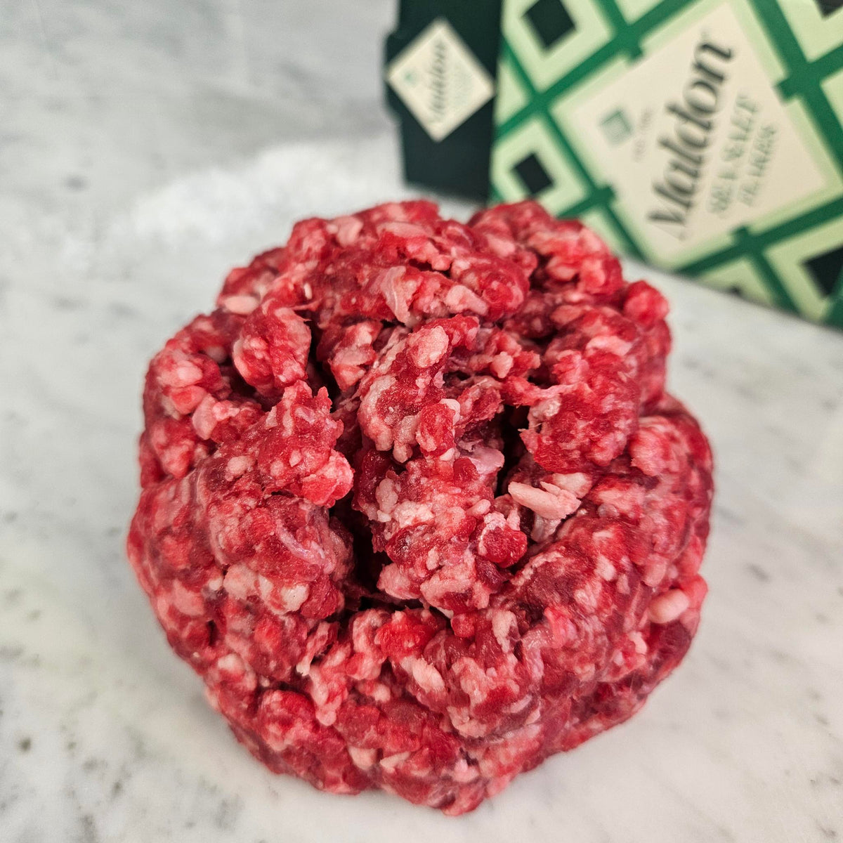 Fresh grass-fed ground water buffalo on white marble with Maldon sea salt — Wishbone Heritage Farms, South Carolina