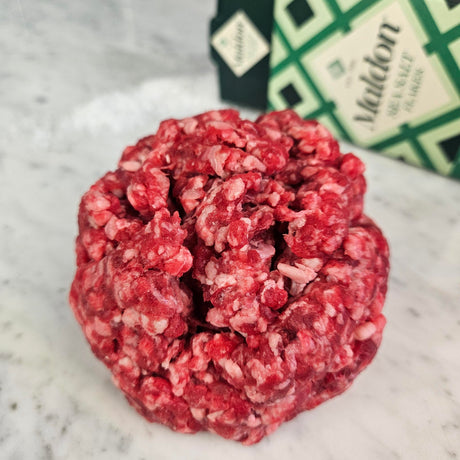 Fresh grass-fed ground water buffalo on white marble with Maldon sea salt — Wishbone Heritage Farms, South Carolina
