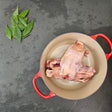 Pasture-raised chicken backs in a red Le Creuset Dutch oven with fresh bay leaves — Wishbone Heritage Farms, Saint George, SC