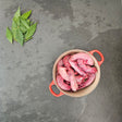 Pasture-raised chicken necks in a red Le Creuset Dutch oven with fresh bay leaves — Wishbone Heritage Farms, Saint George, SC