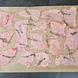 Pasture-raised chicken skins seasoned with black pepper and fresh thyme on a parchment-lined baking sheet — Wishbone Heritage Farms, Saint George, SC