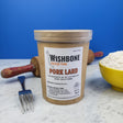 Wishbone Heritage Farms pasture raised pork lard 32oz container with rolling pin, fork, and bowl of flour