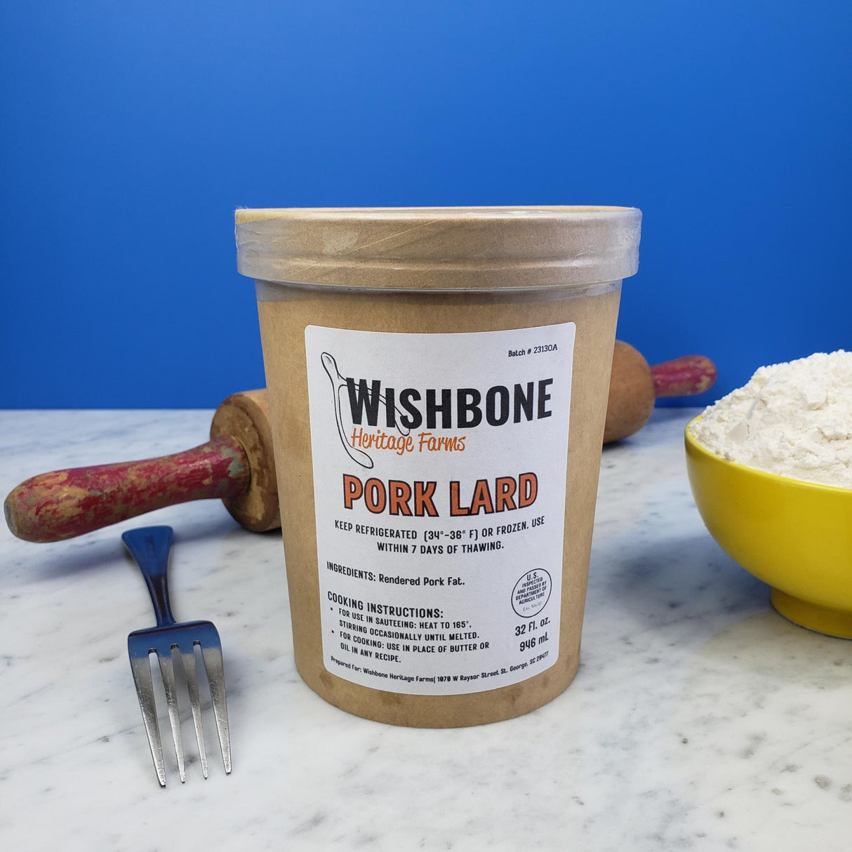 Wishbone Heritage Farms pasture raised pork lard 32oz container with rolling pin, fork, and bowl of flour