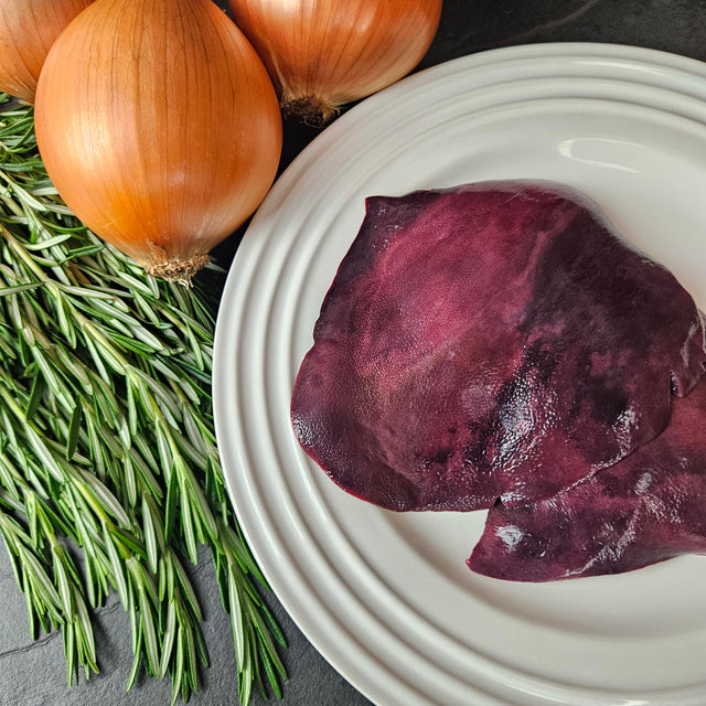 Pasture-raised heritage pork liver slices on a white plate with fresh rosemary and yellow onions — Wishbone Heritage Farms, Saint George, SC